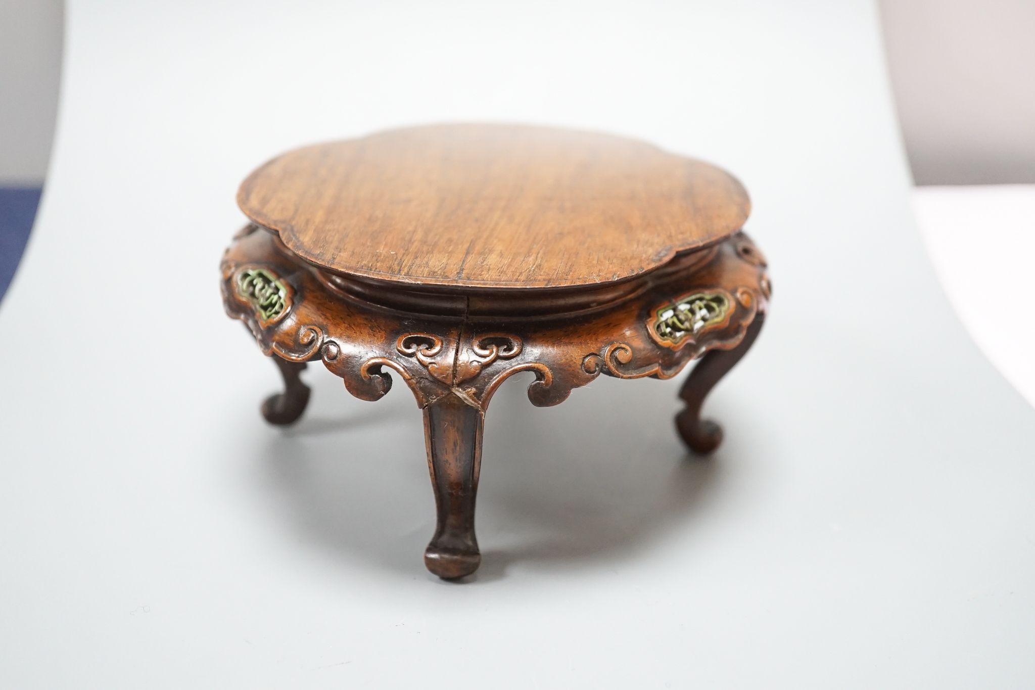 A fine Chinese oval hardwood and green stained Ivory inset stand, Qing dynasty, lacking stretcher, 15 cms wide.